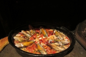 cook in wood fired oven til rice showing at the top , snuggle in the mussels
